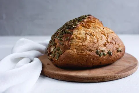 Rye bread on a board on a white tablecloth background Stock Photos