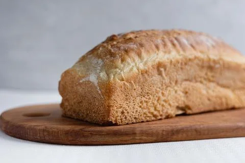 Rye bread on a board on a white tablecloth background Stock Photos