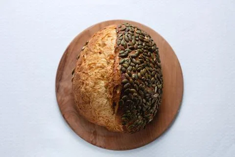 Rye bread on a board on a white tablecloth background Stock Photos