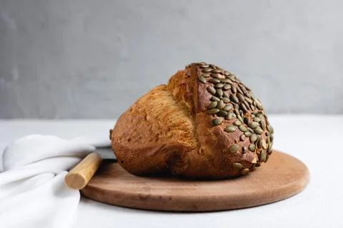 Rye bread on a board on a white tablecloth background Stock Photos