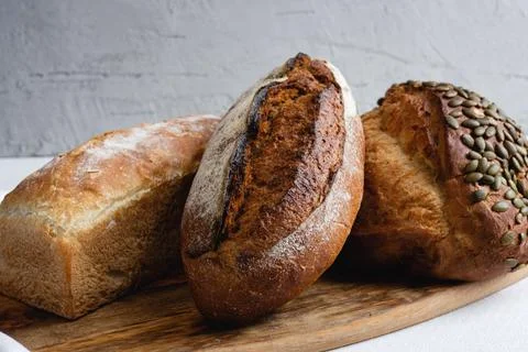 Rye bread on a board on a white tablecloth background Stock Photos