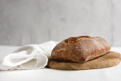 Rye bread on a board on a white tablecloth background Stock Photos