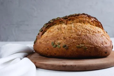 Rye bread on a board on a white tablecloth background Stock Photos