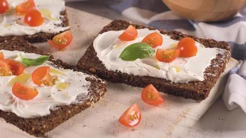 Rye bread with cream cheese and cherry tomatoes Stock Photos