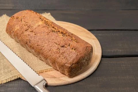Rye bread on dark wooden table with copy space. Fotos de archivo