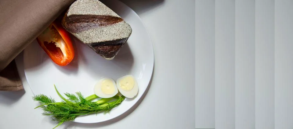 Rye bread, egg and pepper on a white background Stock Photos