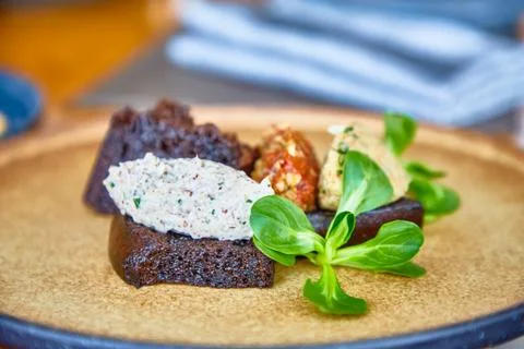 Rye bread with paste of nuts lying on the plate. Stock Photos