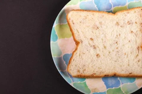 Rye bread on a plate on black background Stock Photos