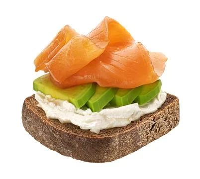 Rye bread slice with smoked salmon and avocado isolated on white background 库存照片