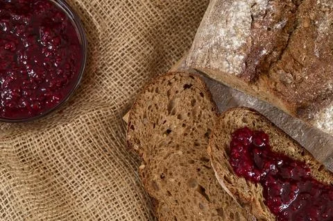 Rye bread slices spread with fruit jam it top view Stock Photos