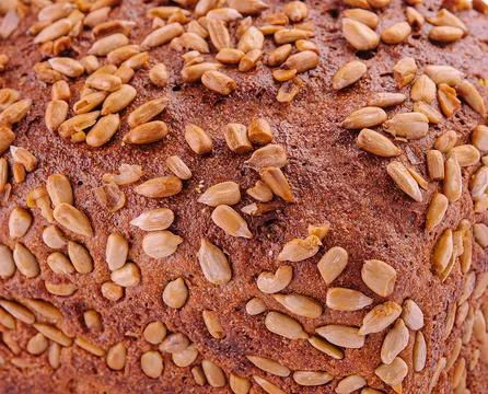 Rye bread with sunflower seeds on a white Stock Photos