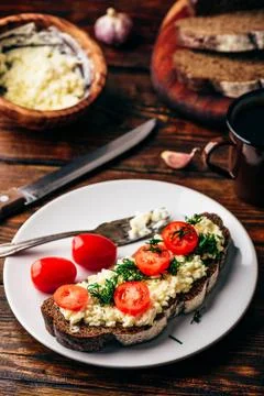 Rye bread toast with processed cheese, garlic and tomatoes Stock Photos