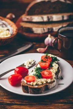 Rye bread toast with processed cheese, garlic and tomatoes Stock Photos