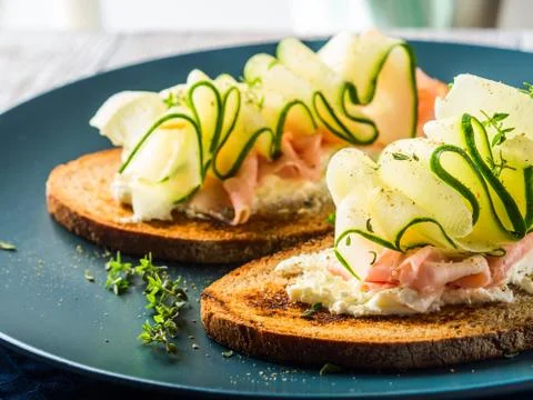 Rye bread toasts with cheese, ham, cucumber Stock Photos