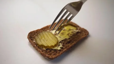 Rye bread topped with pickles and ham Stock Footage 322533171