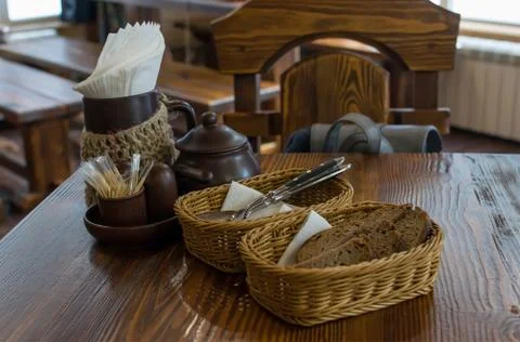 Rye bread in wicker baskets on the table and Cutlery in the restaurant Stock Photos