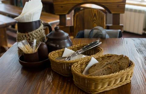 Rye bread in wicker baskets on the table and Cutlery in the restaurant Stock Photos