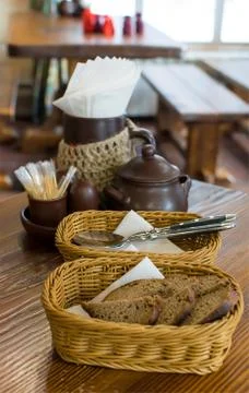 Rye bread in wicker baskets on the table and Cutlery in the restaurant Stock Photos