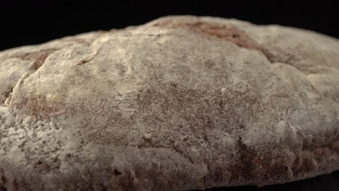 Rye ciabatta bread close up on black background Stock Footage 140534848