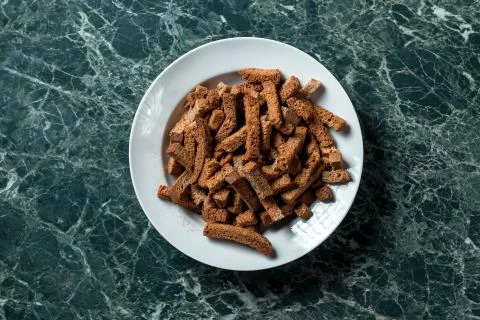 Rye crackers on green marble background view from above Stock Photos
