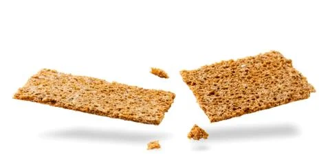 Rye crispbread broken in half flying on a white background. Stock Photos