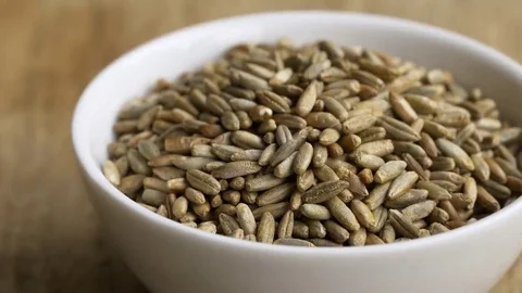 Rye grains falling into a small bowl Stock Footage 69166151