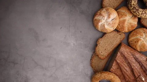 Rye organic bread, bugles with sesame and buns appear on right side-Stop motion 스톡 동영상 131392282