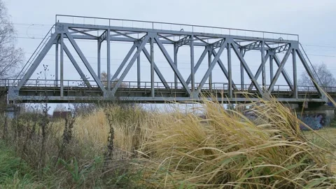RZD suburban train is crossing the small bridge over water Stock Footage 150361880