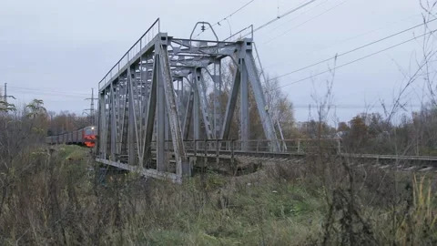 RZD suburban train is crossing the small bridge over water Stock Footage 150433461