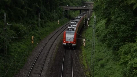 S-bahn train leaving from under a bridge in Munich Stock Footage 133020966