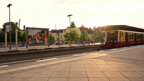 S-Bahn Train stopping at Station in Berlin during Sunset. People waiting Stock Footage 195820554