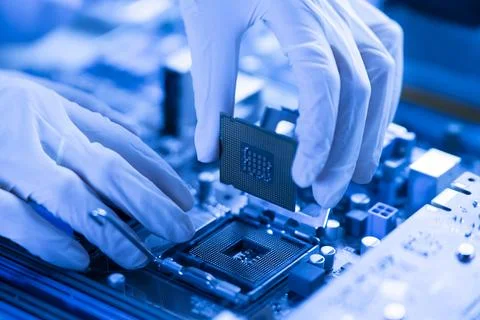 S hand insert processor cpu chip in the socket of motherboard, computer assembly Stock Photos