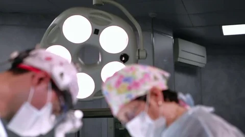 S-Petersburg, Oct. 2016. Two surgeons and surgical light in surgery room during Stockbeeldmateriaal 72736744