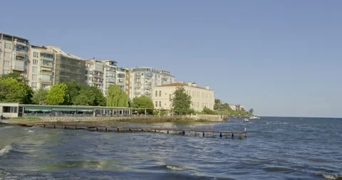 S serene waves gently lapping against a coastal town's shore. Sinop, Turkey Stock Footage 296586591