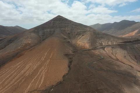 S-Shaped Road Descending Through the Desert Valley Stock Photos