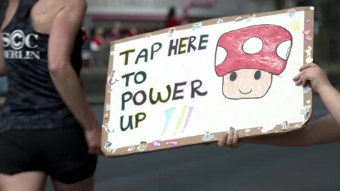 S25 marathon runners tap power sign SlowMo Berlin 2023 Stock Footage 332126445
