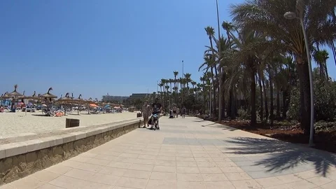 Sa Coma Mallorca Spain: Tourists walking and cycling on the beach promenade Stockbeeldmateriaal 81091399