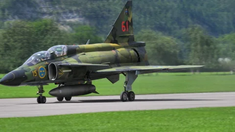 Saab 37 Viggen slows down on the runway after landing using its thrust reverser Stock Footage 146309542