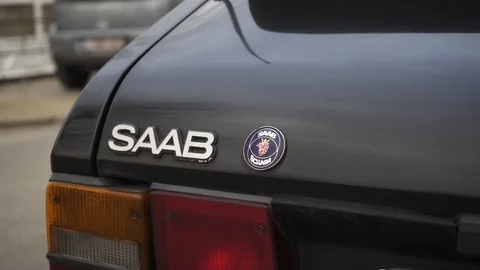 A Saab logo both written and the logo itself on the back of a black car. A Stock Footage 105161338