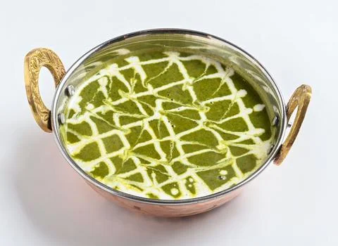 Saag Chicken Curry with Cream Garnished in a Traditional Copper Bowl isolat.. Stock Photos