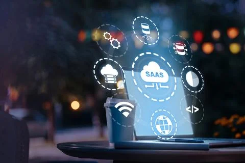 Saas software displayed on a laptop screen with icons and a coffee cup on a Stock Photos