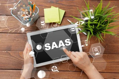 Saas software displayed on tablet with workspace items including plant and Stock Photos