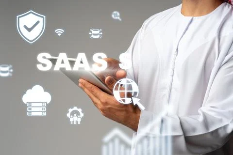 Saas technology concept with a person using a tablet and digital icons in a Fotos Stock
