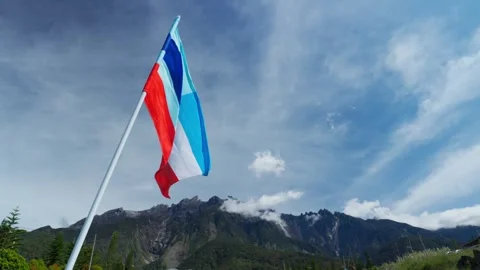 Sabah flags in the wind in front of mount kinabalu (slow motion) Stock Footage 300849864