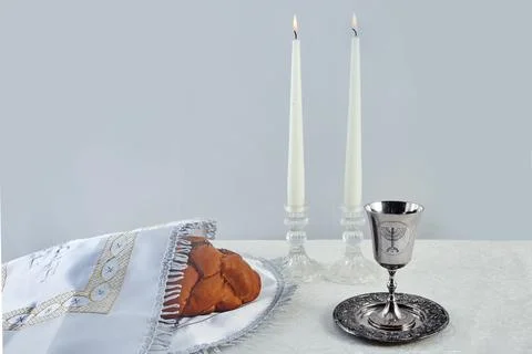Sabbath Table Setting. Challah bread, candles, and a kiddush cup Stock Photos