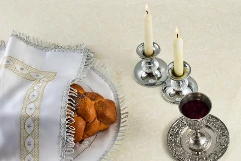 Sabbath Table Setting. Elegant Sabbath table with braided bread, candles, and Stock Photos