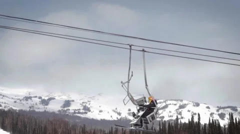 Сableway winter. Snow forest and skiers on a ski lift Stock Footage