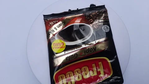 Sachet coffee grounds on a rotating display Stock Footage 246631880