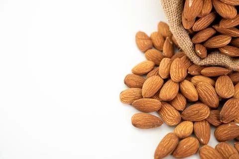 Sack with almond on white background. (selective focus; close-up shot) 写真素材