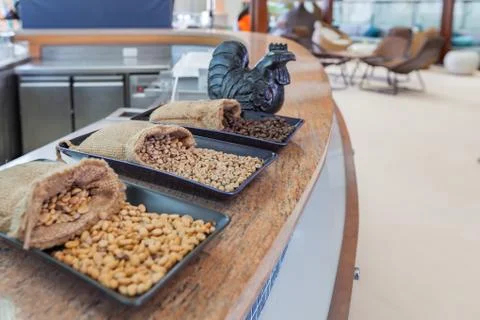 Sack of coffee grains on table Stock Photos